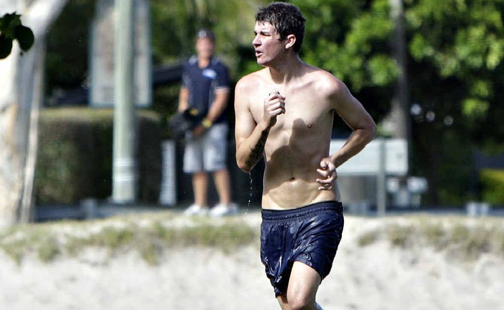 A young man, wanted for questioning by police and who did a runner, jogs away from police in Mooloolaba, a television cameraman watches from across the way. A young man, wanted for questioning by police and who did a runner, jogs away from police in Mooloolaba, a television cameraman watches from across the way.